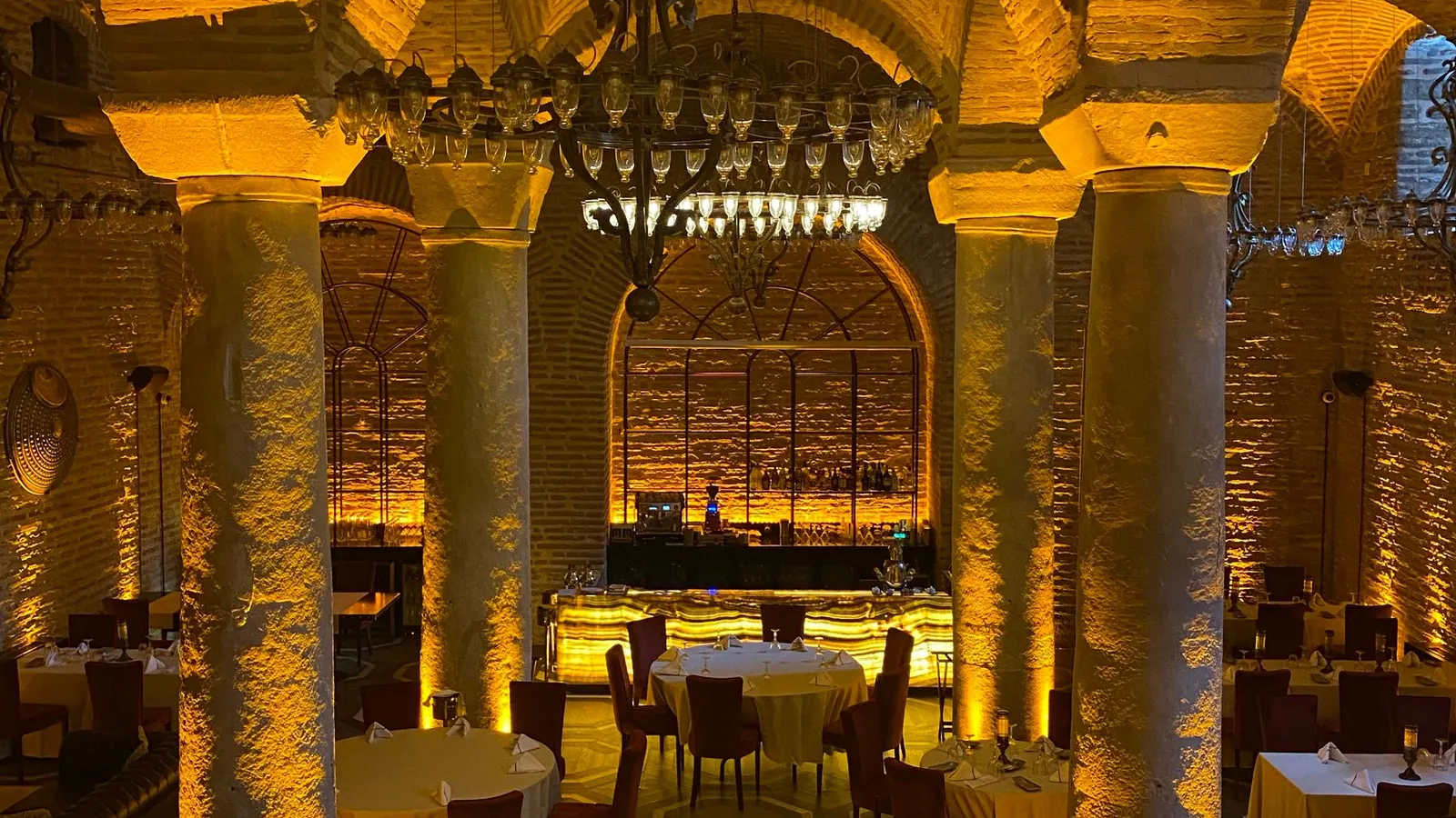 Warm premium arched interior used as a mood image for a possible shezan.be hospitality direction